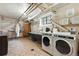 Large laundry room with tile floors, front load washer and dryer, and plenty of storage space at 3132 E 17Th Ave # B, Denver, CO 80206