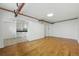 Spacious living space featuring hardwood floors, an arched doorway, and exposed piping at 3132 E 17Th Ave # B, Denver, CO 80206