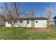 View of the backyard showcasing the back of the house and green door at 280 Birch St, Bennett, CO 80102