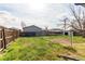 Backyard with chainlink fence, wooden fence, and grass at 280 Birch St, Bennett, CO 80102