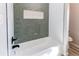 Bathroom featuring green subway tile in the shower, a soap holder, and updated shower fixtures at 280 Birch St, Bennett, CO 80102
