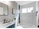 Bright bathroom with a shower and tub combination, modern vanity and stylish design at 280 Birch St, Bennett, CO 80102