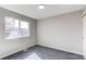 Well-lit bedroom with plush carpet, neutral walls and a large window at 280 Birch St, Bennett, CO 80102