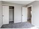 Bedroom with gray carpet, neutral paint, and a walk-in closet near the entrance at 280 Birch St, Bennett, CO 80102