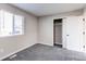 Bedroom with closet featuring sliding doors, a window with blinds, gray walls and carpet at 280 Birch St, Bennett, CO 80102