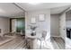 Bright dining area adjacent to the kitchen features modern light fixture and view to Gathering area at 280 Birch St, Bennett, CO 80102