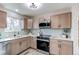 Modern kitchen featuring stainless steel appliances, wood cabinets, and sleek countertops at 280 Birch St, Bennett, CO 80102