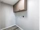 Laundry room featuring overhead cabinets, and utility hookups at 280 Birch St, Bennett, CO 80102