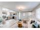 Open-concept living room features light hardwood floors, modern ceiling fan and flows into the kitchen at 280 Birch St, Bennett, CO 80102