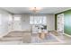 View of the front door and living area, filled with natural light and stylish decor at 280 Birch St, Bennett, CO 80102