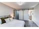 Inviting main bedroom showcasing barn doors that lead to the closet and the en-suite bathroom at 280 Birch St, Bennett, CO 80102