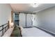 Spacious main bedroom with a comfortable bed and barn doors to the closet and en-suite bath at 280 Birch St, Bennett, CO 80102