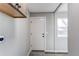 Mud room with wood cabinets, a door to the outside, neutral paint, and vinyl flooring at 280 Birch St, Bennett, CO 80102