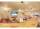 Finished basement with a leather couch, tv, and bar perfect for entertaining at 6699 S Robb St, Littleton, CO 80127