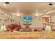 Finished basement with a leather couch, tv, and bar perfect for entertaining at 6699 S Robb St, Littleton, CO 80127