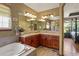 Bathroom featuring soaking tub, cherry cabinets, double sinks and walk-in shower at 6699 S Robb St, Littleton, CO 80127