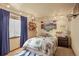 Bedroom features unique decor, overhead lighting, and comfortable carpet at 6699 S Robb St, Littleton, CO 80127
