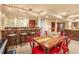 Dining Area features a wet bar, unique chairs and table, and a light fixture at 6699 S Robb St, Littleton, CO 80127
