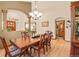 Formal dining room featuring hardwood floors, modern light fixtures, and neutral wall colors at 6699 S Robb St, Littleton, CO 80127