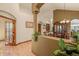 Open-concept dining room features hardwood floors and elegant chandelier for comfortable entertaining at 6699 S Robb St, Littleton, CO 80127