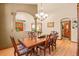 Formal dining room featuring hardwood floors, modern light fixtures, and neutral wall colors at 6699 S Robb St, Littleton, CO 80127