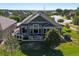 Well-maintained home featuring an expansive deck, lush lawn, and meticulous landscaping at 6699 S Robb St, Littleton, CO 80127