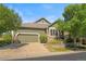 Traditional home showcasing a stone facade, manicured lawn, and two-car garage at 6699 S Robb St, Littleton, CO 80127