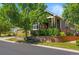 Charming home with a well-kept lawn, stone accents, and mature landscaping at 6699 S Robb St, Littleton, CO 80127