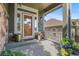 Inviting front porch featuring stone accents, decorative door, and colorful potted plants at 6699 S Robb St, Littleton, CO 80127