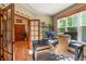 Bright home office with large window, black desk, and comfortable leather chair perfect for working from home at 6699 S Robb St, Littleton, CO 80127