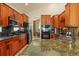 Well-equipped kitchen with dark granite countertops, stainless steel appliances, and ample cabinet space at 6699 S Robb St, Littleton, CO 80127
