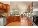 Open kitchen featuring granite countertops, stainless steel appliances, and a view of the living area at 6699 S Robb St, Littleton, CO 80127