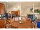 Open-concept with hardwood floors, leading to a modern kitchen and dining area with cozy fireplace at 6699 S Robb St, Littleton, CO 80127