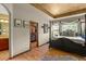 Primary bedroom featuring ensuite, wood floors, tray ceiling, and closet at 6699 S Robb St, Littleton, CO 80127