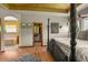 Primary bedroom with wood floors, tray ceiling, ensuite bathroom and walk-in closet at 6699 S Robb St, Littleton, CO 80127