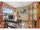 Bright home office featuring hardwood floors, ample natural light, and a modern desk setup at 6699 S Robb St, Littleton, CO 80127