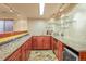 Wet bar with tiled floors, granite countertops, and stainless steel appliances at 6699 S Robb St, Littleton, CO 80127