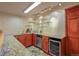 Wet bar with tiled floors, granite countertops, and stainless steel appliances at 6699 S Robb St, Littleton, CO 80127