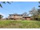 Large, grassy backyard with mature trees, showcasing the home's exterior and outdoor space at 10429 Quivas St, Northglenn, CO 80234