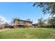 Expansive backyard with a well-maintained lawn, mature trees, and a patio area for outdoor gatherings at 10429 Quivas St, Northglenn, CO 80234