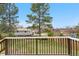 Spacious backyard view from the deck, featuring lush green grass, mature trees, and a fenced perimeter at 10429 Quivas St, Northglenn, CO 80234
