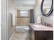 Well-appointed bathroom featuring tiled floors, shower with bathtub, granite countertops, and modern fixtures at 10429 Quivas St, Northglenn, CO 80234