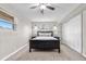 Comfortable bedroom featuring carpet, two windows for natural light, a ceiling fan, and a built-in closet at 10429 Quivas St, Northglenn, CO 80234