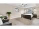 Inviting bedroom featuring two windows for natural light, a ceiling fan, plush carpet, and comfortable furnishings at 10429 Quivas St, Northglenn, CO 80234