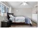 Cozy bedroom with a dark wood bed frame, comfortable bedding, and a window providing natural light at 10429 Quivas St, Northglenn, CO 80234