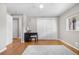 Bedroom featuring hardwood floors, a large window, and soft neutral colors with a workspace at 10429 Quivas St, Northglenn, CO 80234