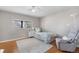 Bedroom features hardwood floors and large window with great light and soft neutral colors at 10429 Quivas St, Northglenn, CO 80234