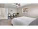 Bright bedroom with neutral walls, a ceiling fan, plush carpet, and comfortable seating beside a large window at 10429 Quivas St, Northglenn, CO 80234