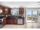 Bright kitchen with stainless steel appliances and sliding glass doors to a deck with beautiful views at 10429 Quivas St, Northglenn, CO 80234