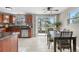 Eat-in kitchen features stainless steel appliances, granite counters, and access to the backyard deck at 10429 Quivas St, Northglenn, CO 80234